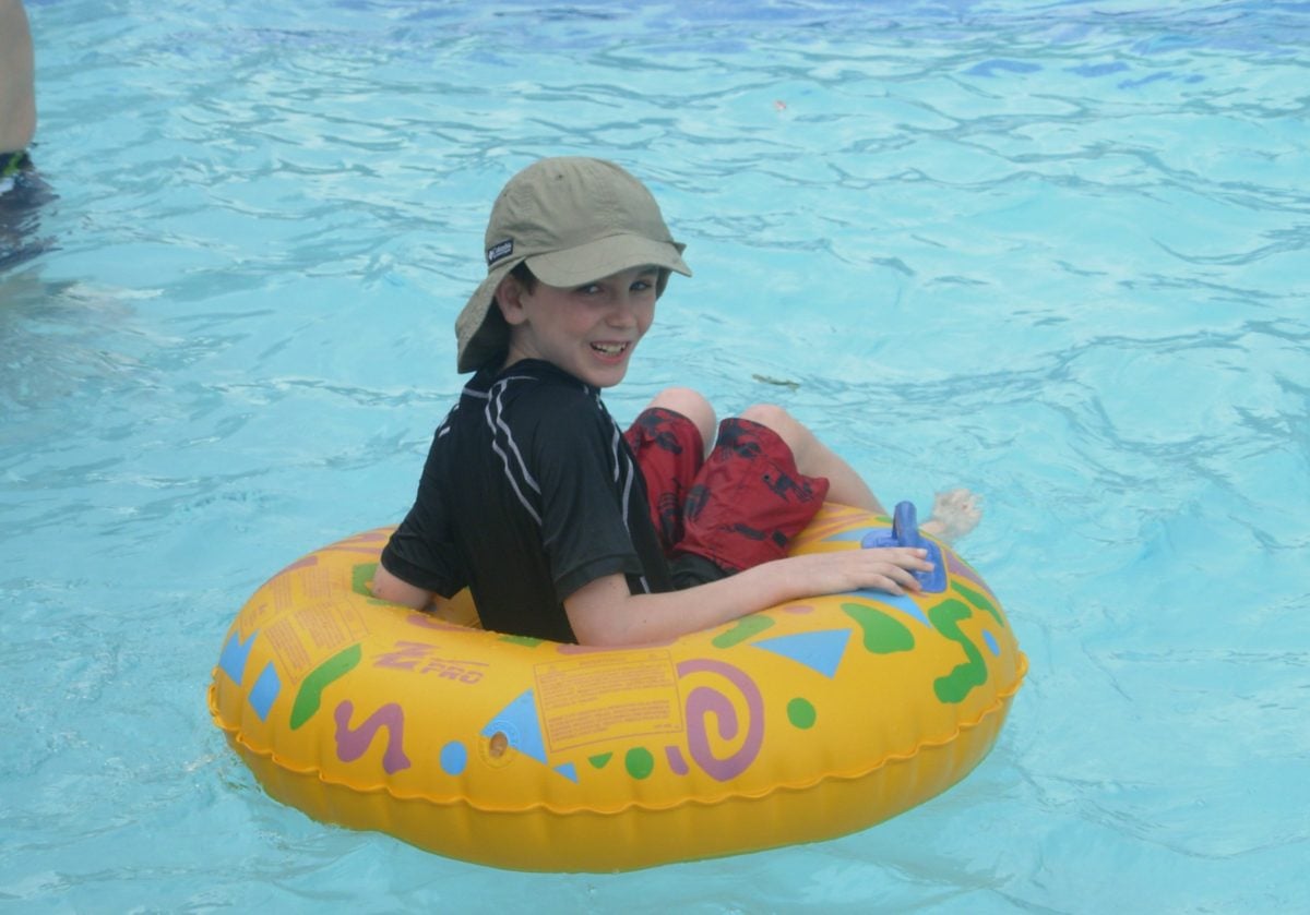 Lucas floating on water slide tube in pool Ocho Rios Jamaica