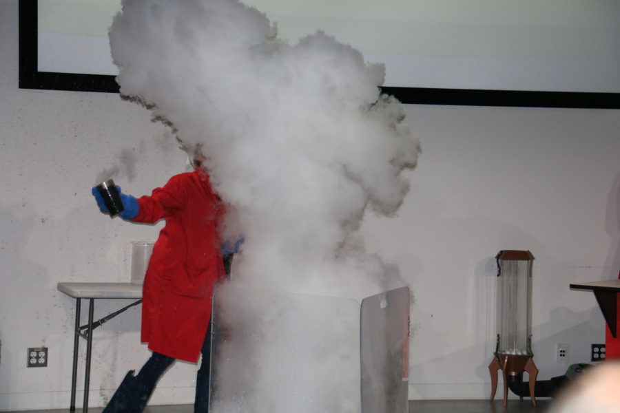the scientist creates a big puff of steam as liquid nitrogen is added