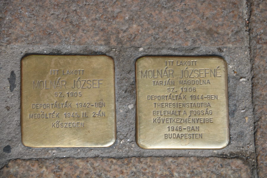 image taken on Budapest walking tour of two brass squares side by side engraved with names and dates with Budapest private guide