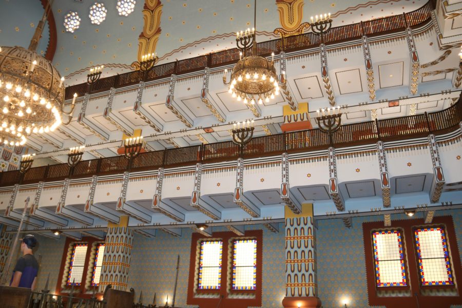 image towards the ceiling of the Kazinczy synagogue including intricate painting of tulips leading to the balcony above