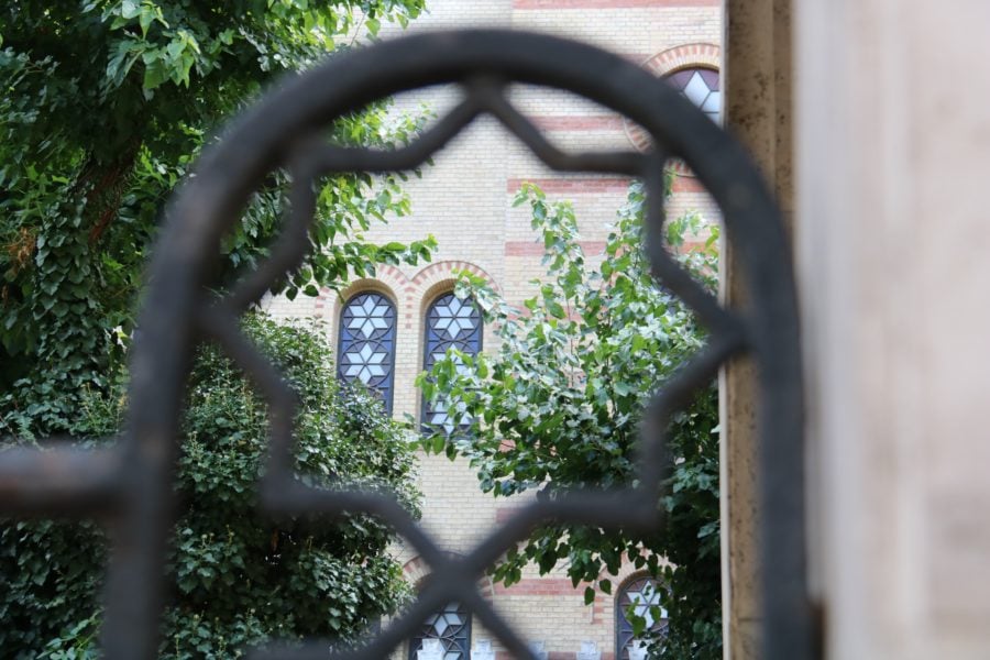 image of top sight in Budapest a window of the dohany synagogue while looking through a star of David in the cast iron fence