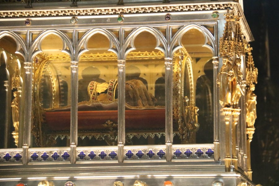 image of gold chest with glass walls and mummified hand inside