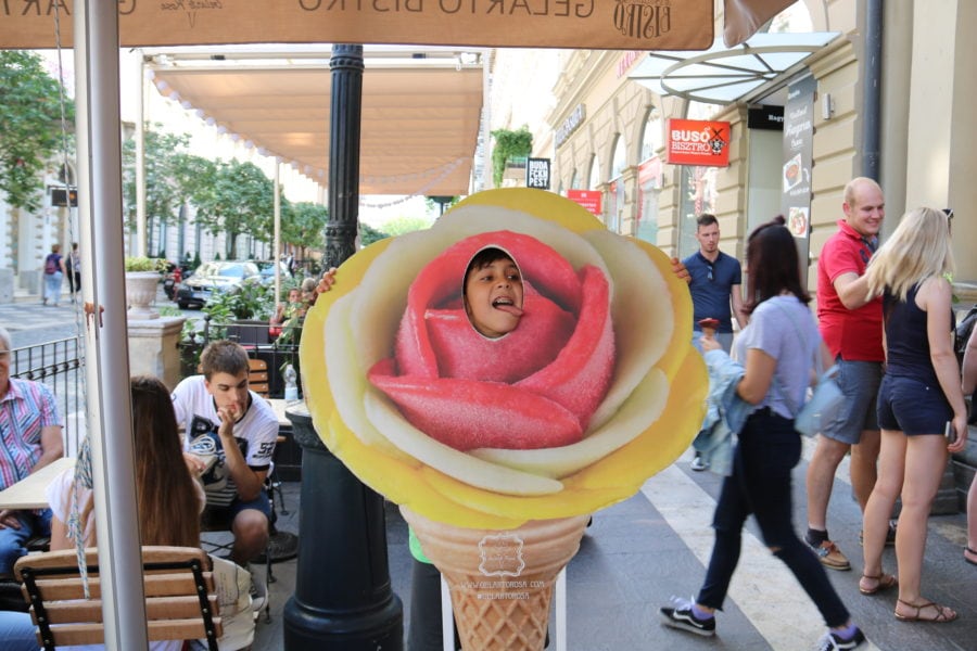 image of kid in budapest licking cardboard ice cream display