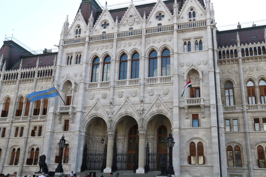 image of the front of Parliament building with the light blue Transylvanian flag and the traditional Hungarian flag flying