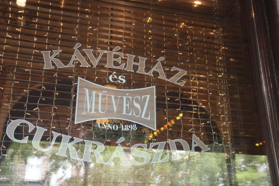 from window with logo for restaurant Muvesz Kavehaz in Budapest