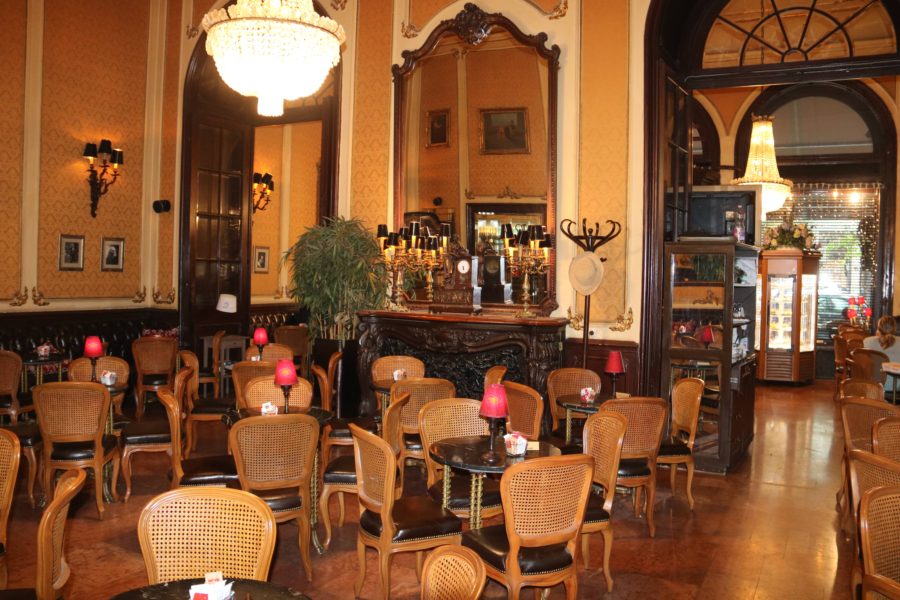 interior of Muvesz Kavehaz restaurant in Budapest with dark wood finishings and wicker chairs is one of best restaurants in Budapest
