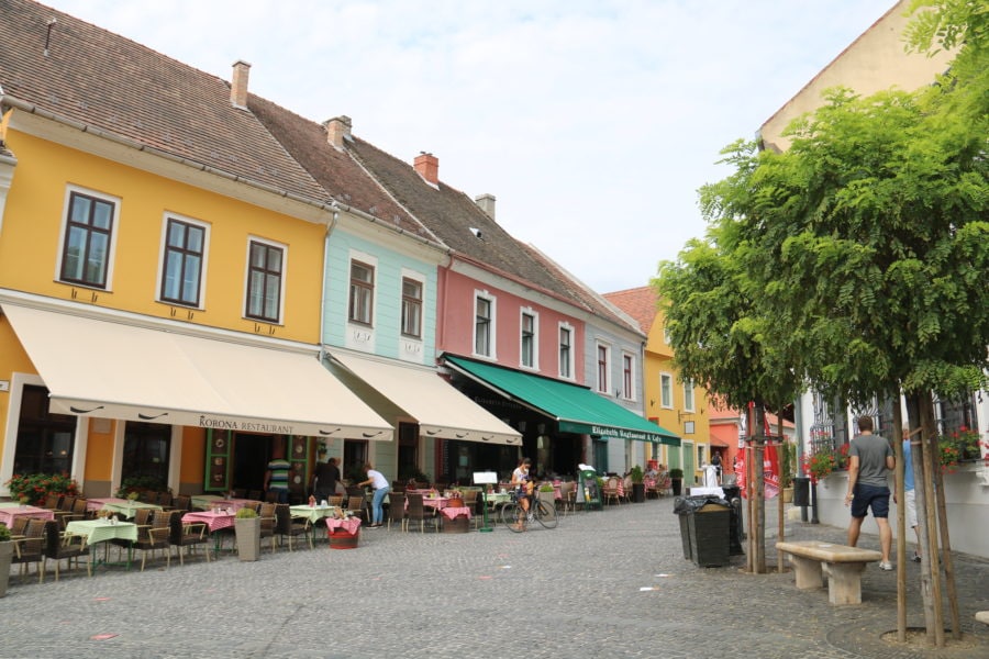 image of several shops/houses with pastel colours and awnings in Szentendre Danube Bend tour