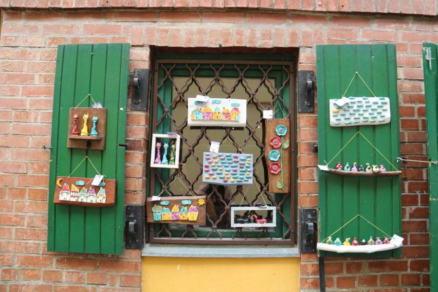 image of store window with ceramic animals on the shutters