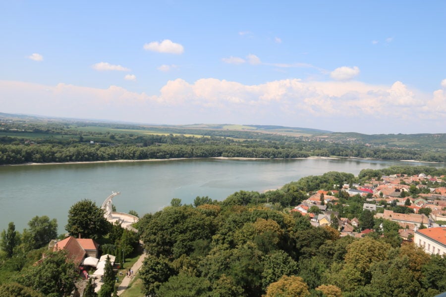 image of the Danube Bend with trees and orange rooftops of Esztergom on our day trip from Budapest