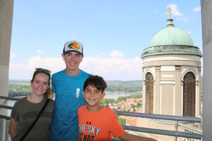image of my three kids taken at top of tower with part of basilica tower in background