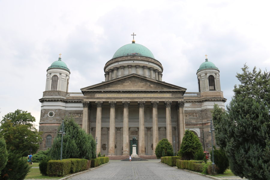 image of the front of white basilica with pillars and dome