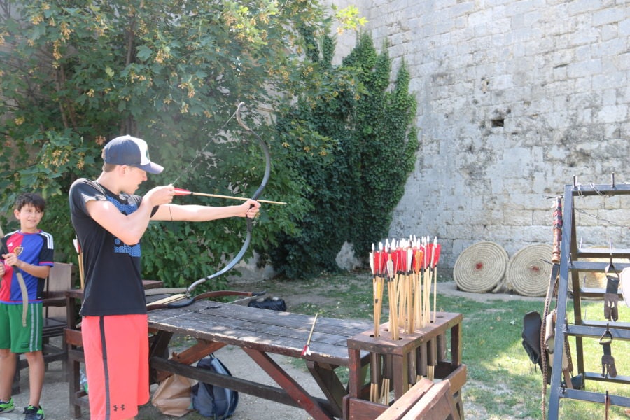 image of kid in Budapest shooting arrow at target
