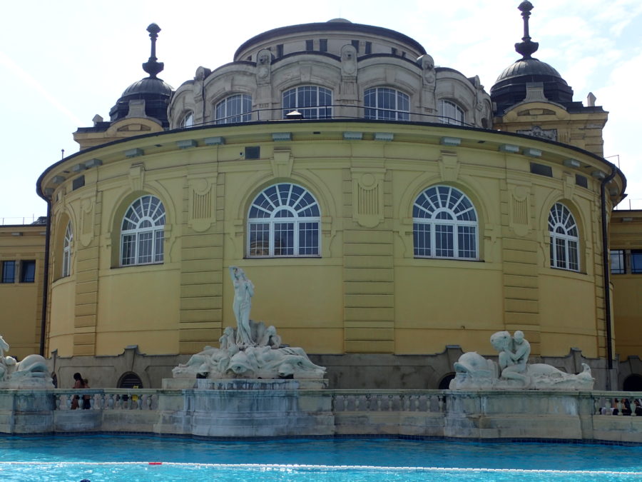 image of the central architecture in the area of the lap pool including white statues with yellow background