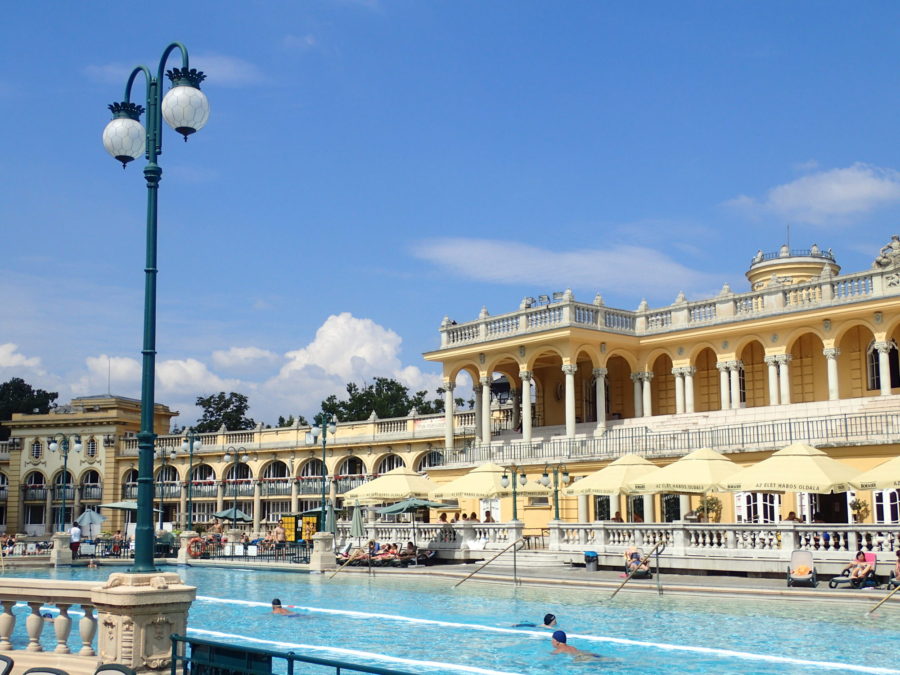 image of the lap pool at Budapest's Szechenyi Baths with beautiful yellow architecture in the background