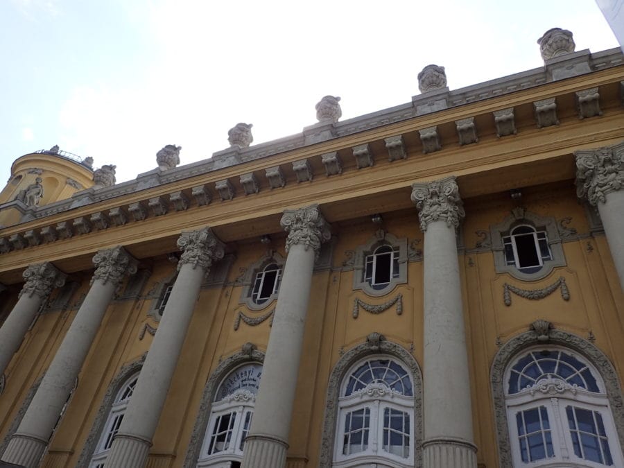 image of yellow and white plaster exterior of Budapest's Szechenyi Baths including columns