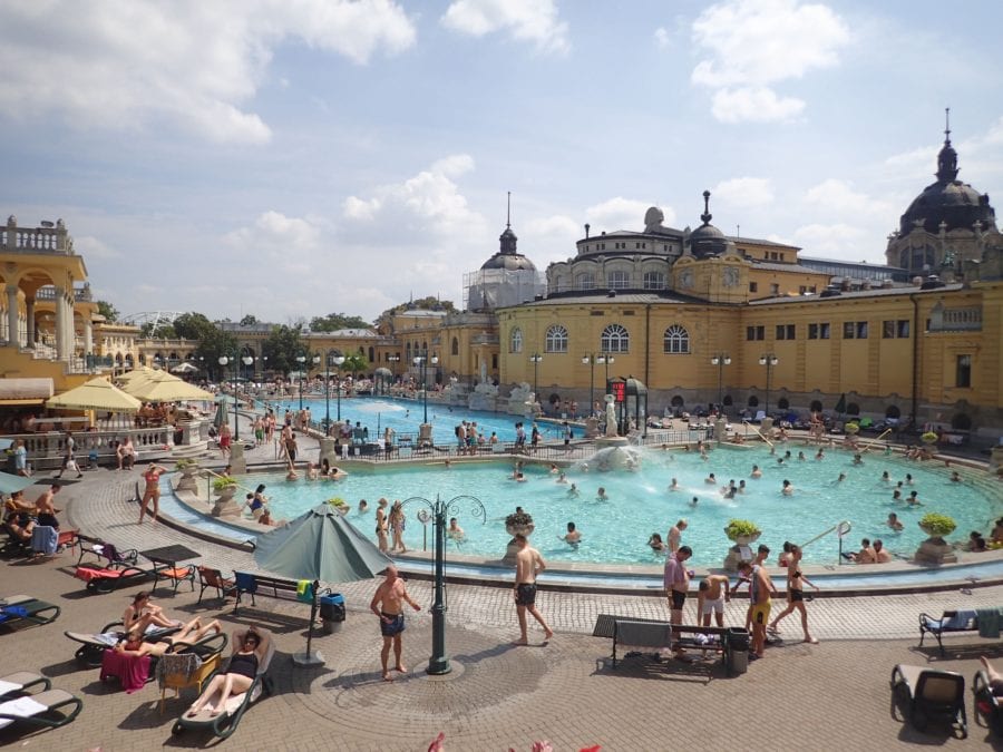 image of the baths with beautiful yellow building in background is top Budapest activities