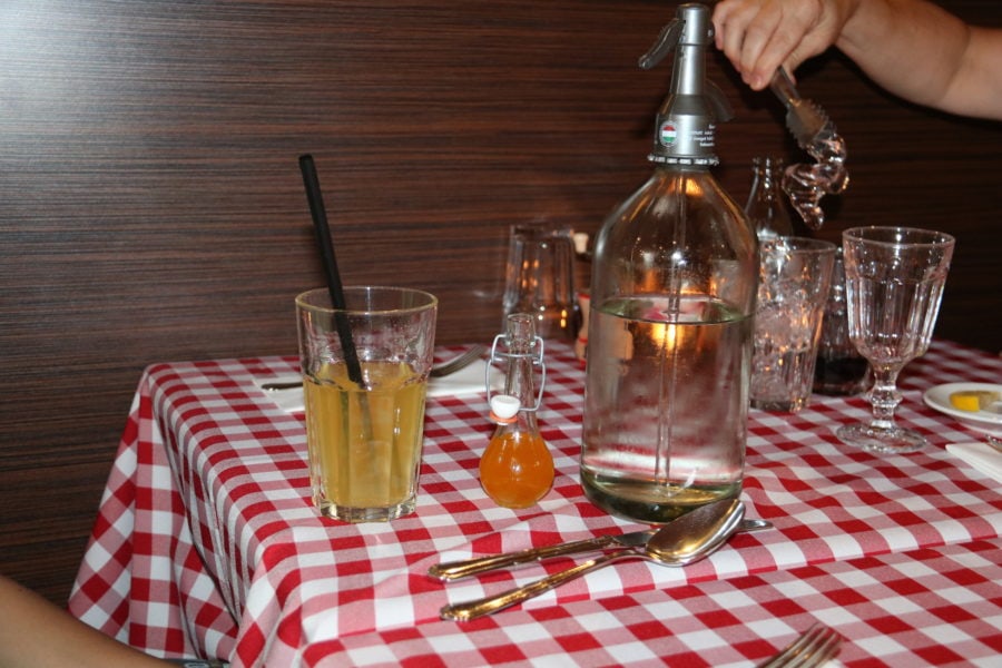 homemade soda water on table with red check table cloth 