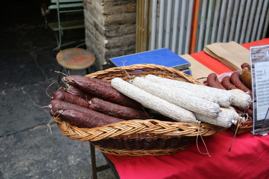 a basket with regular and white salami which is a great Budapest food to try