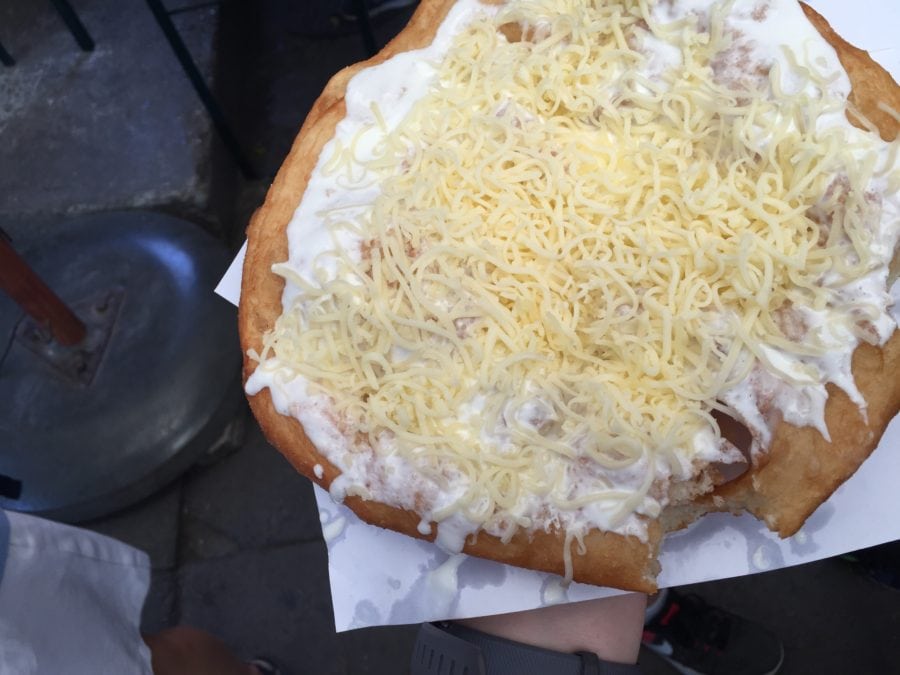 close up of langos with garlic sauce sour cream and cheese is amazing Budapest food