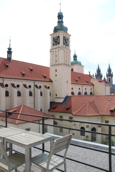image of large church with towers of other church behind Prague family apartment