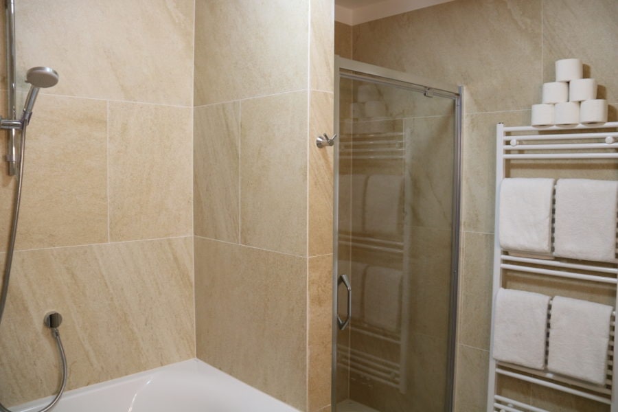 image of large shower with glass door and bath
