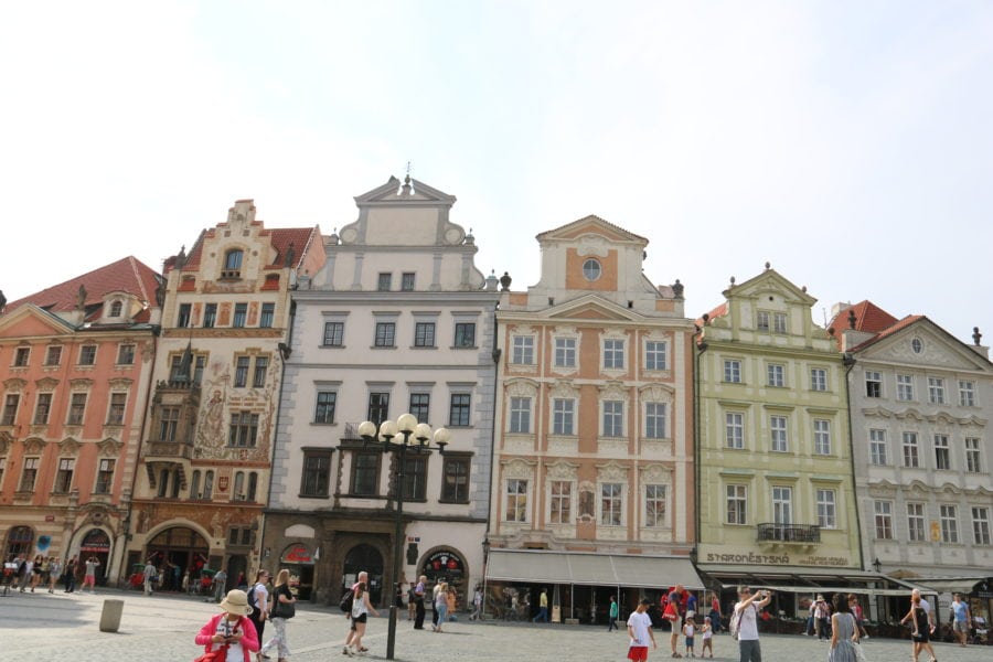 image of Old Town Square with colourful row houses including orange house is fun thing to do in Prague