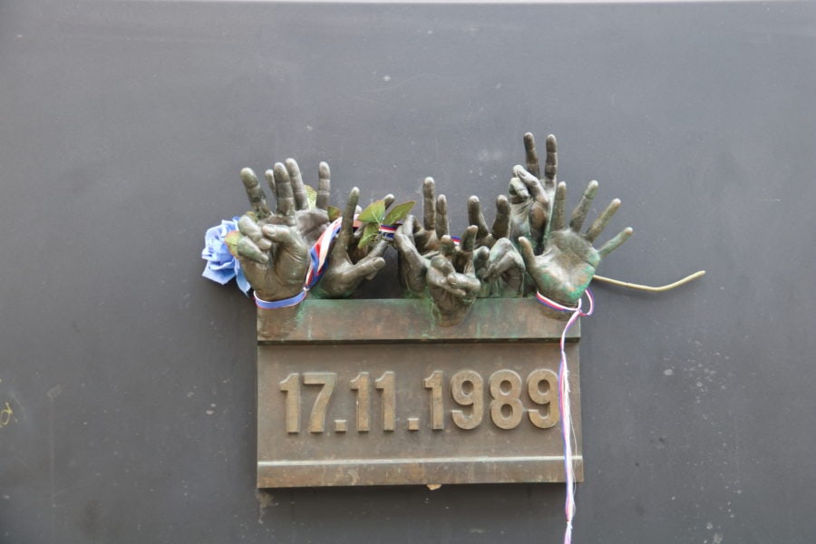image of brass hand coming from a box attached to a wall dated November 17 1989 Prague