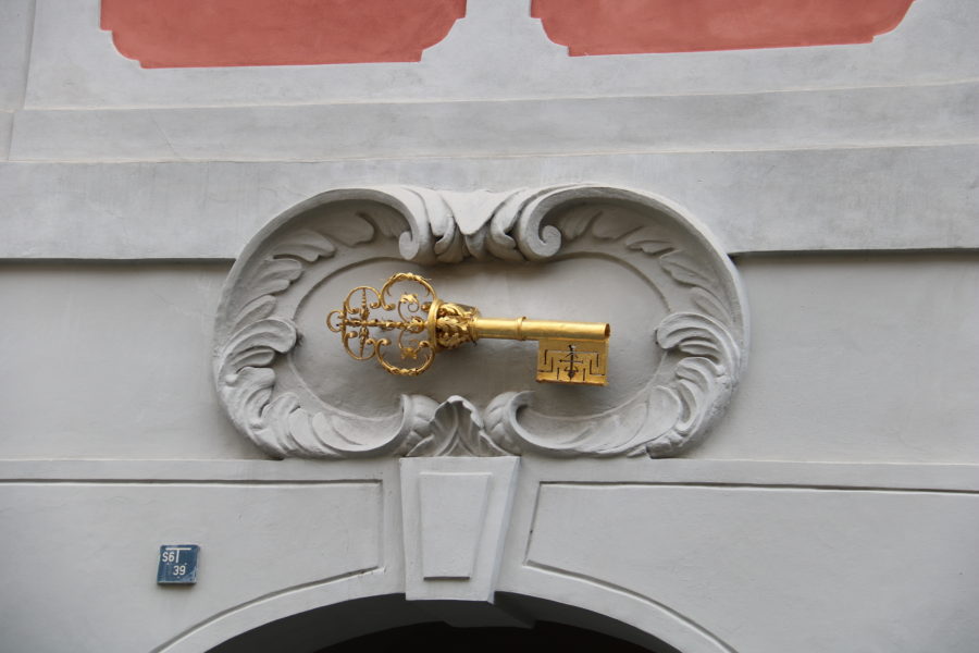 image of a golden key above a doorway