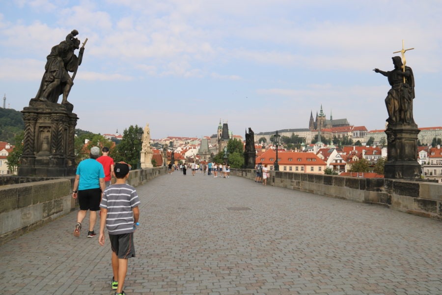 image of us walking across an empty Charles Bridge Prague