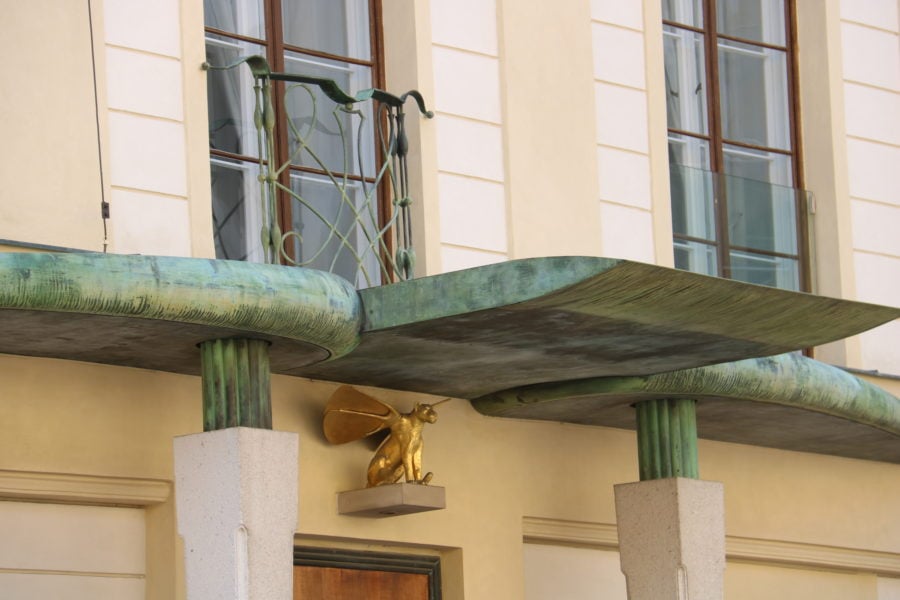 image of green marble awning with gold winged cat below