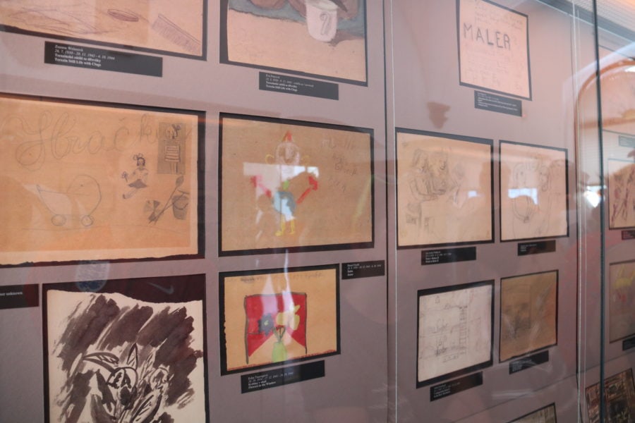 images of children's drawings behind glass