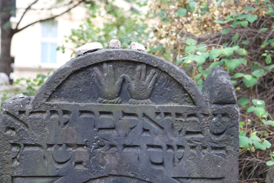 image of a headstone with two hands side by side Prague Jewish Cemetery