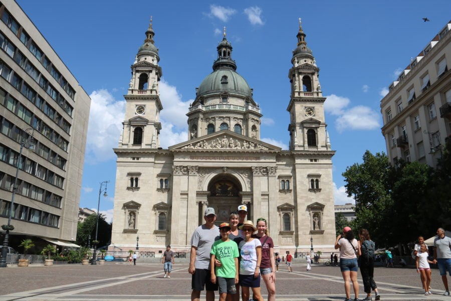 image of our family in front of church with green dome on day one of Budapest itinerary