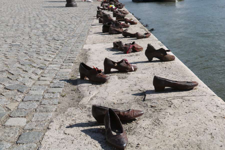 image of brown shoes on edge of Danube River day 1 of Budapest Itinerary