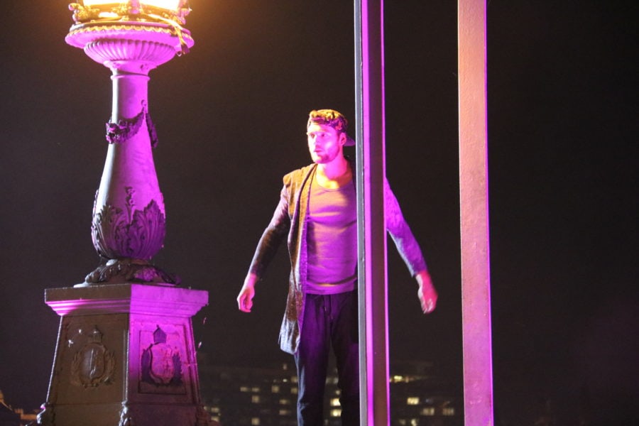 image of a man with dark hair and purple lights on railing