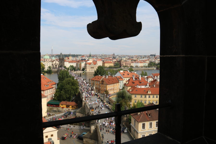 image of Charles Bridge as viewed through decorative arch is fun thing to do in Prague