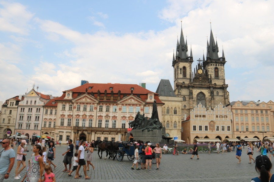 image of Prague Old Town Square looking at beautiful facades tyn church and Hus statue