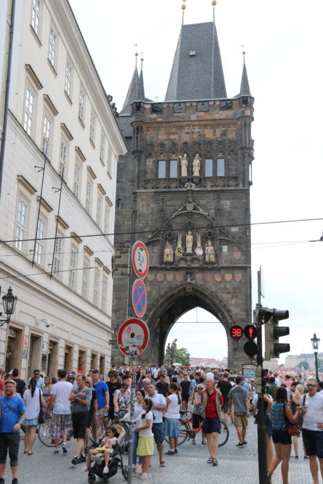 image of large stone tower with archway and lots of people during 3 days in Prague