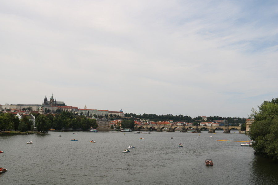 image of vltava river with kayakers and boaters