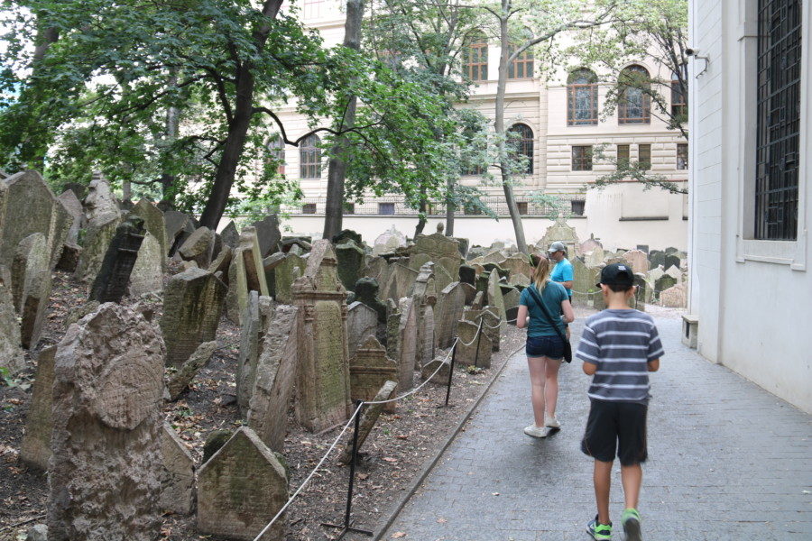 image of the kids walking through Old Jewish Cemetery with many head stones