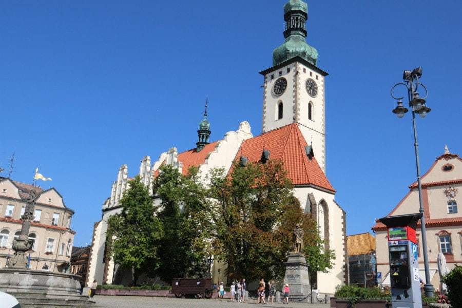 image of white and orange church with church tower of green in Tabor Czech Republic