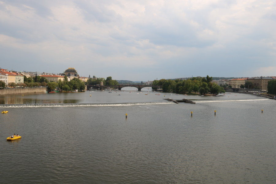 image of green island in distance next to another bridge during 3 days in Prague