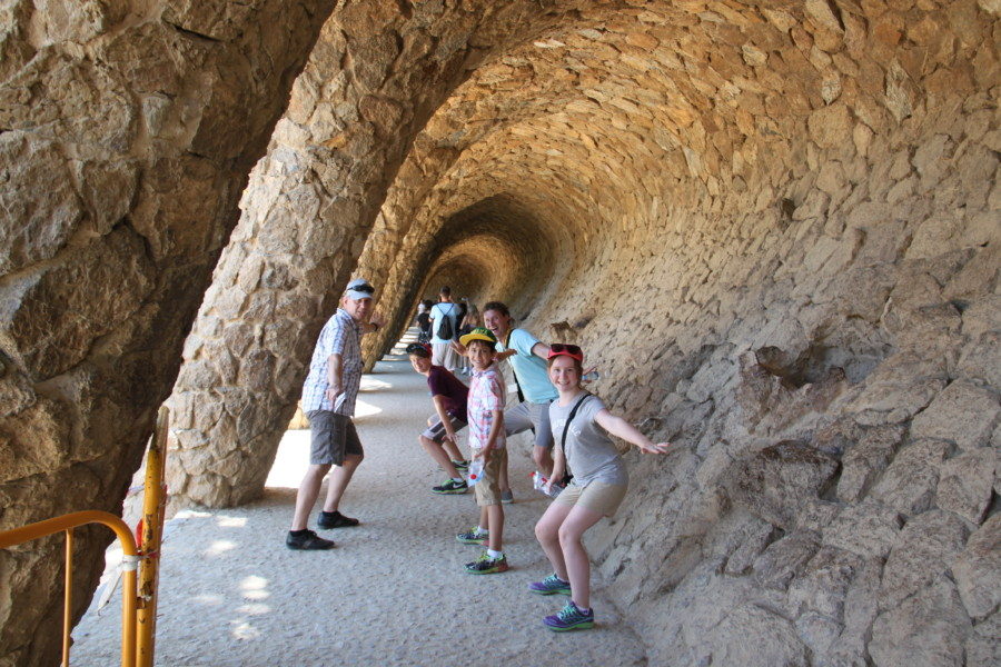 image of kids with private guide in Barcelona pretending to surf at Park Guell