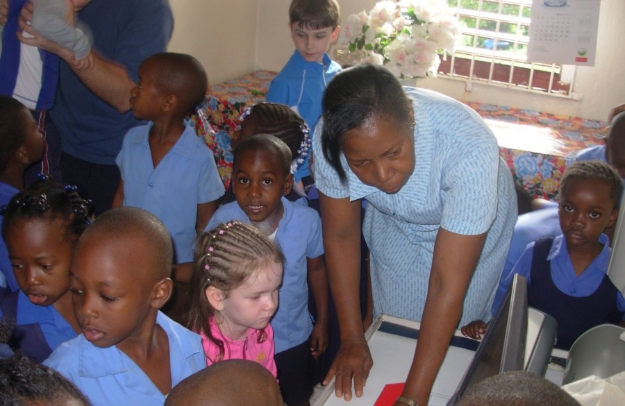 image of my kids attending school with jamaican kids during school visit
