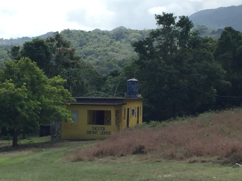 image of Jamaica school visit primary school small yellow building in field