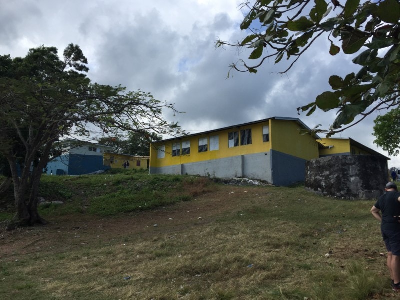 image of yellow Jamaica school on hill