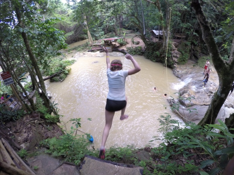 image of Jessica jumping off cliff at Blue Hole Jamaica things to do