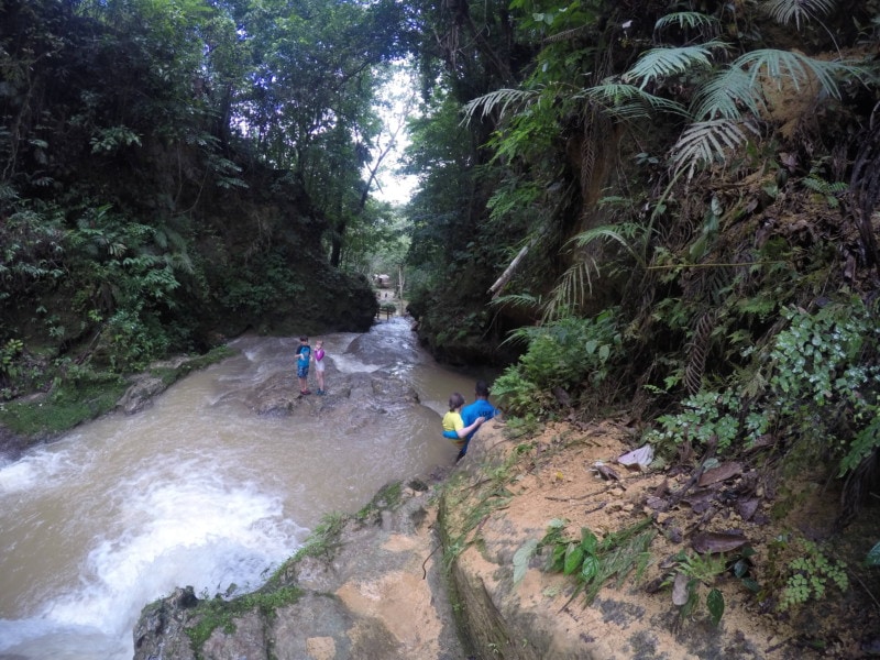 image of large pool of water and guide walking down along side Blue Hole Jamaica