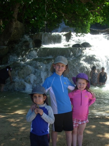 three kids in front of Dunn's River Falls Jamaica things to do