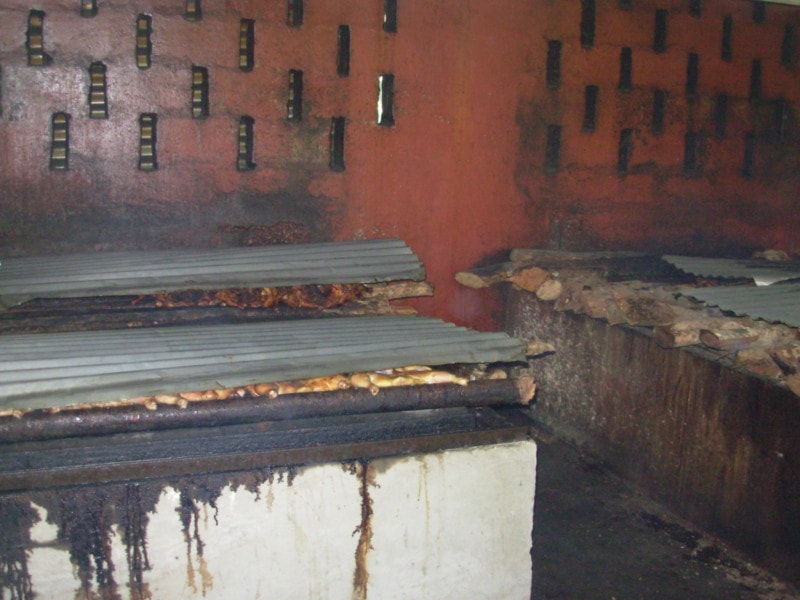 food cooking with steel plates on top and bamboo on bottom at Scotchies Jamaica things to do
